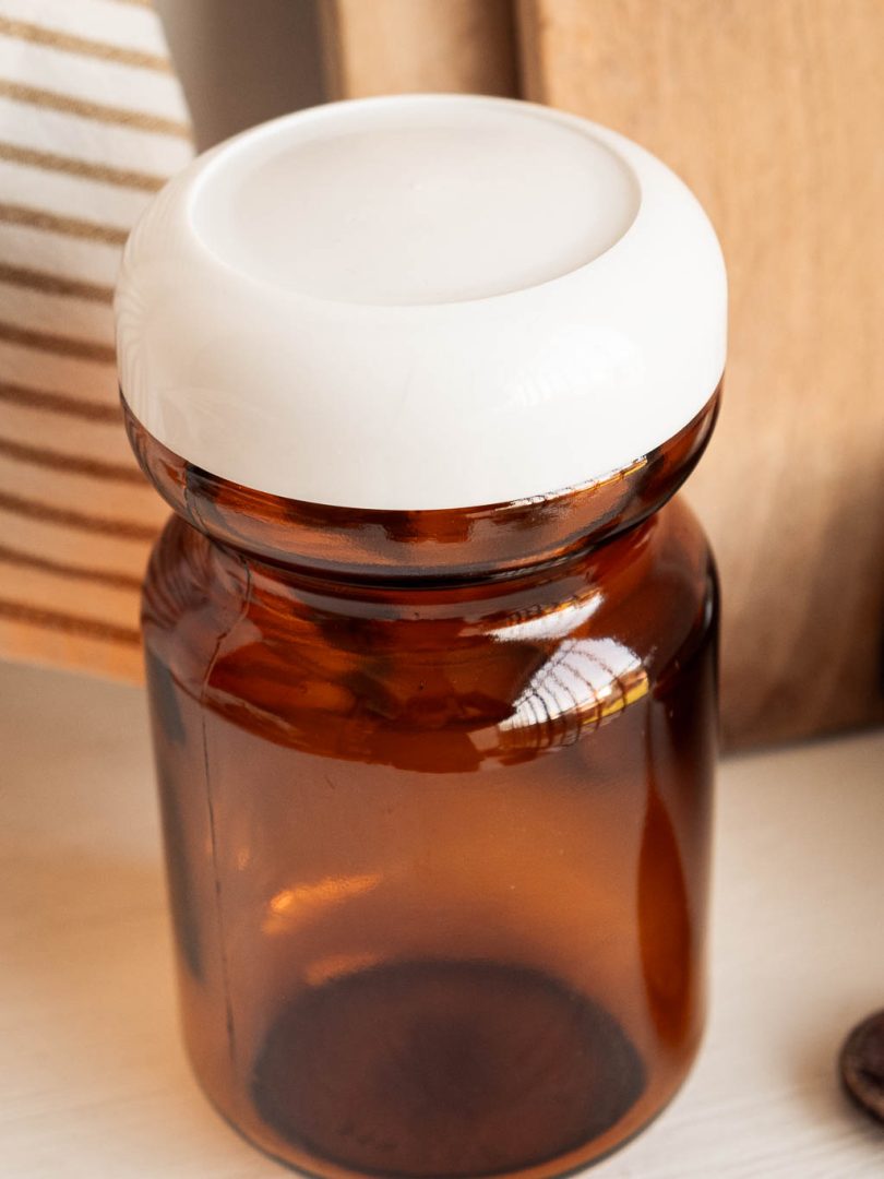 bocal en verre ambré vintage avec son bouchon en plastique blanc